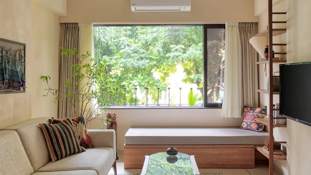 Space-saving furniture hacks for small rooms, with a person relaxing in a clutter-free living room.