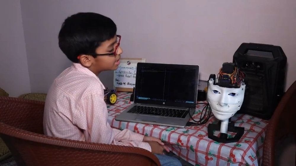 Muhammad Hasnain, 12-year-old Pakistani student, with his AI-powered robot, showcasing innovation and STEM excellence"