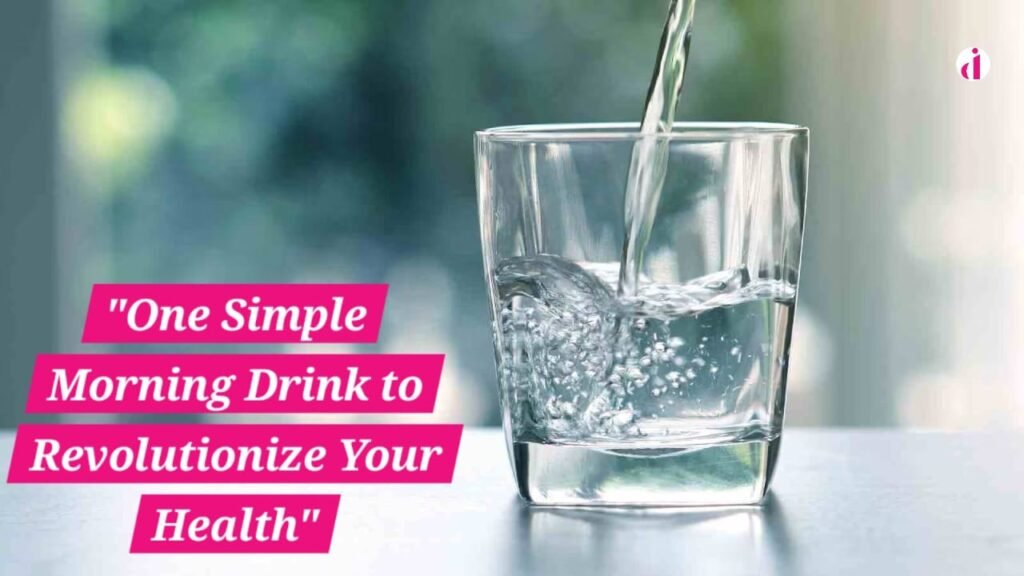 A glass of warm lemon water with a slice of lemon on the rim, placed on a wooden table.